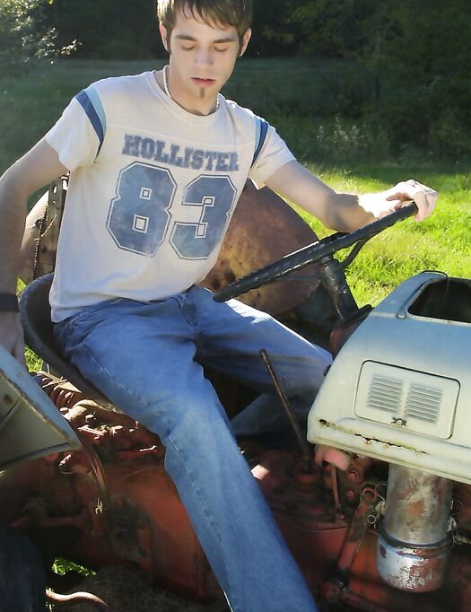 Twink with a hairy ass Ryan undresses and strokes his boner on a tractor